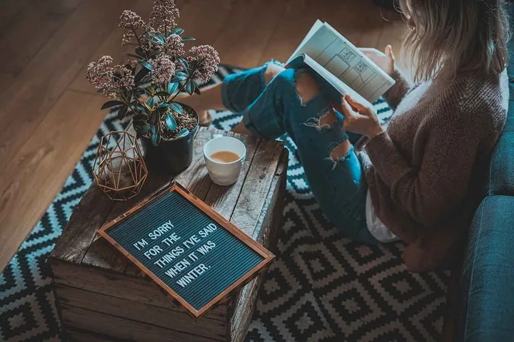 Girl sitting on floor in front of couch