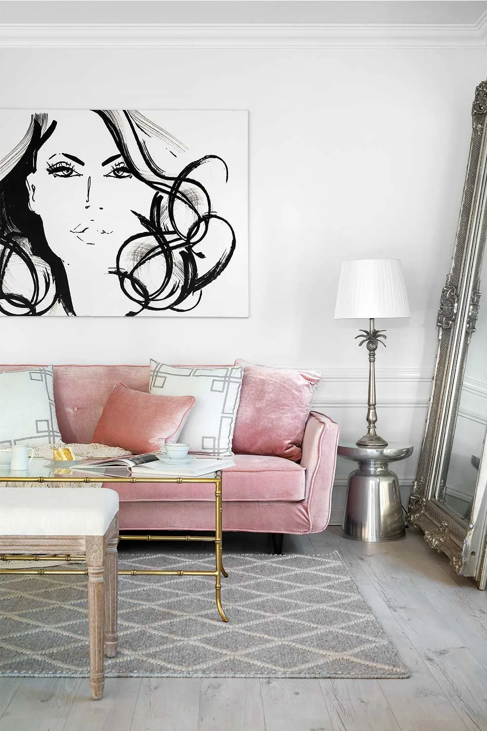 Dusty pink sofa below artwork by Kerrie Hess