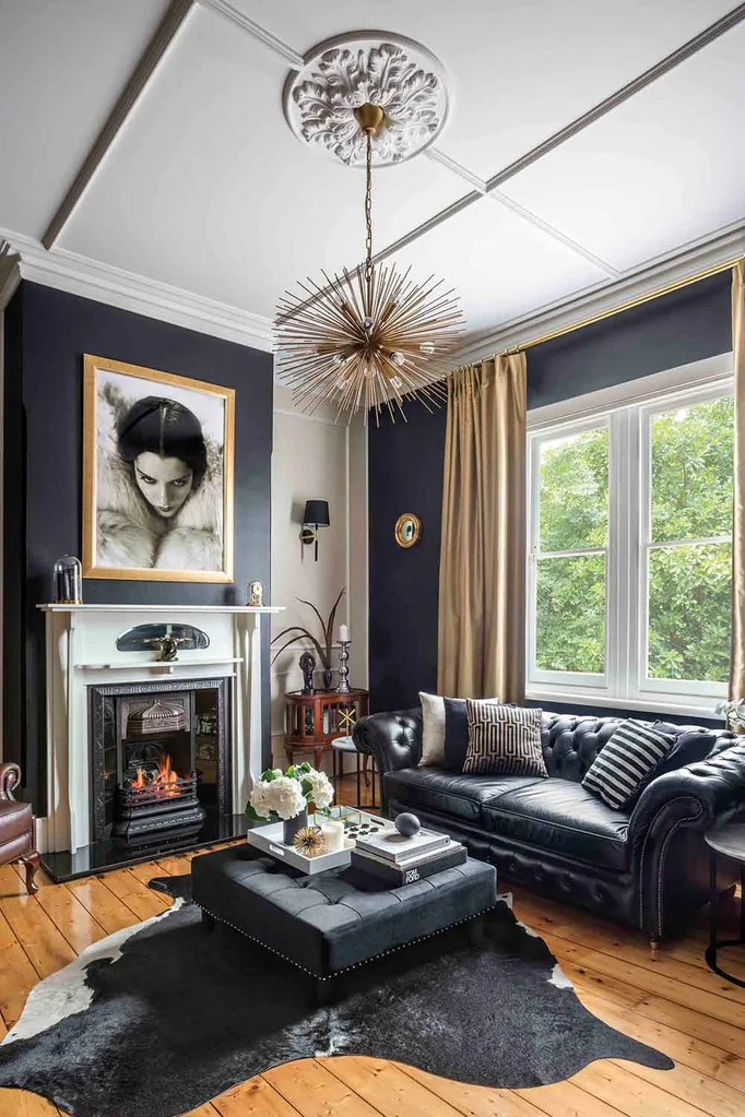 Art deco style living room with statement lighting, hide rug and feature fireplace