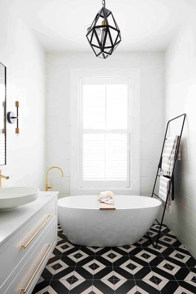 Stunning monchrome bathroom with freestanding bathtub and graphic black and white tiles