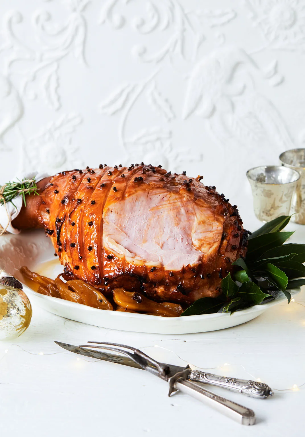 Glazed ham on a white platter