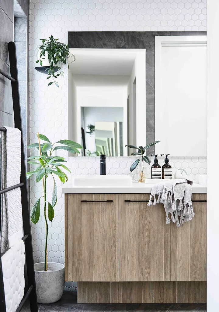 Matt black Caroma taps and the Polytec Ravine cabinetry bring luxe to the ensuite.