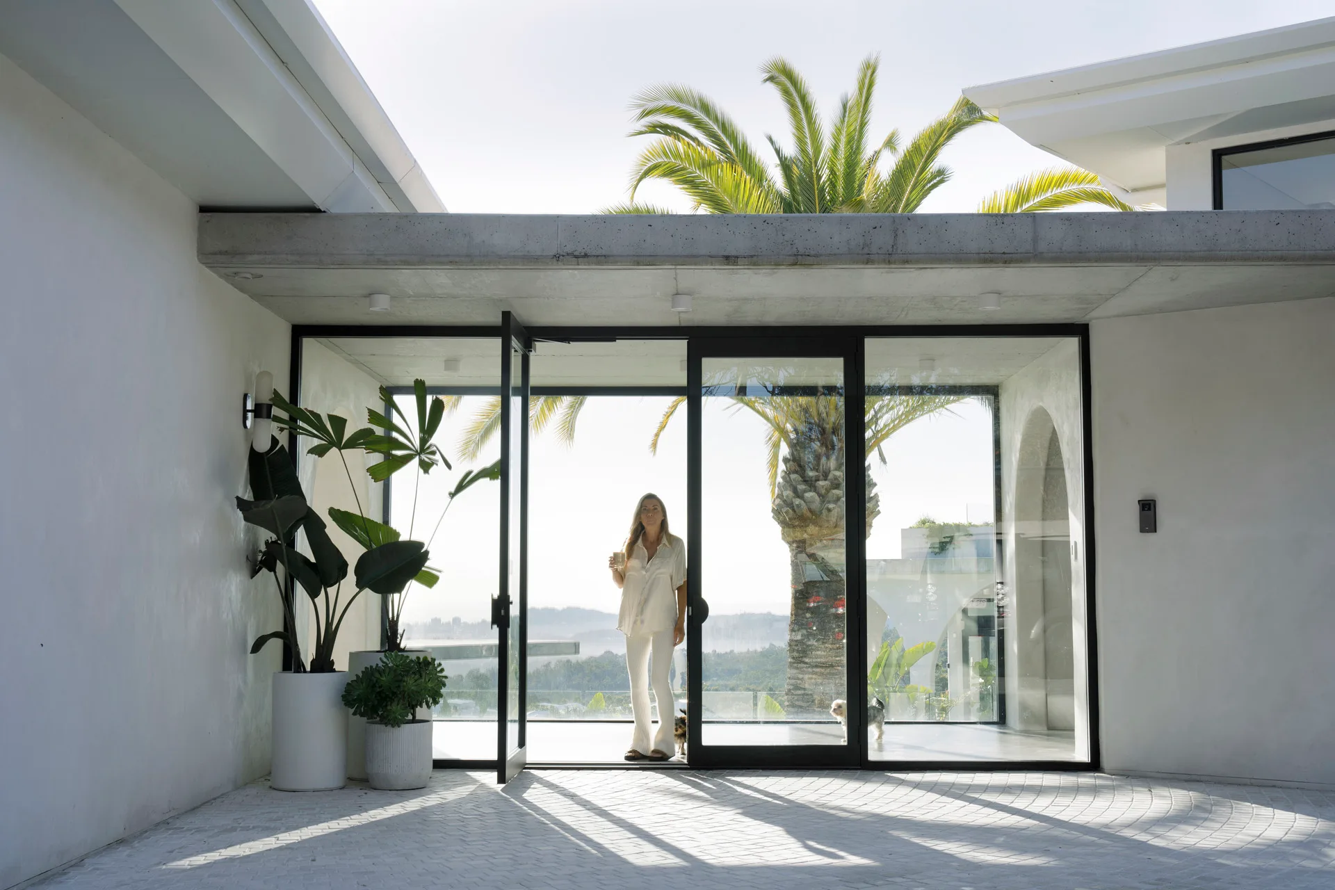 breezeway in contemporary all white rendered home