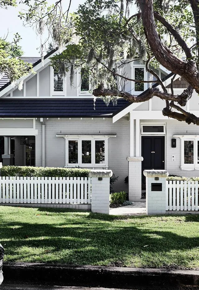 heritage home exterior with white picket fence