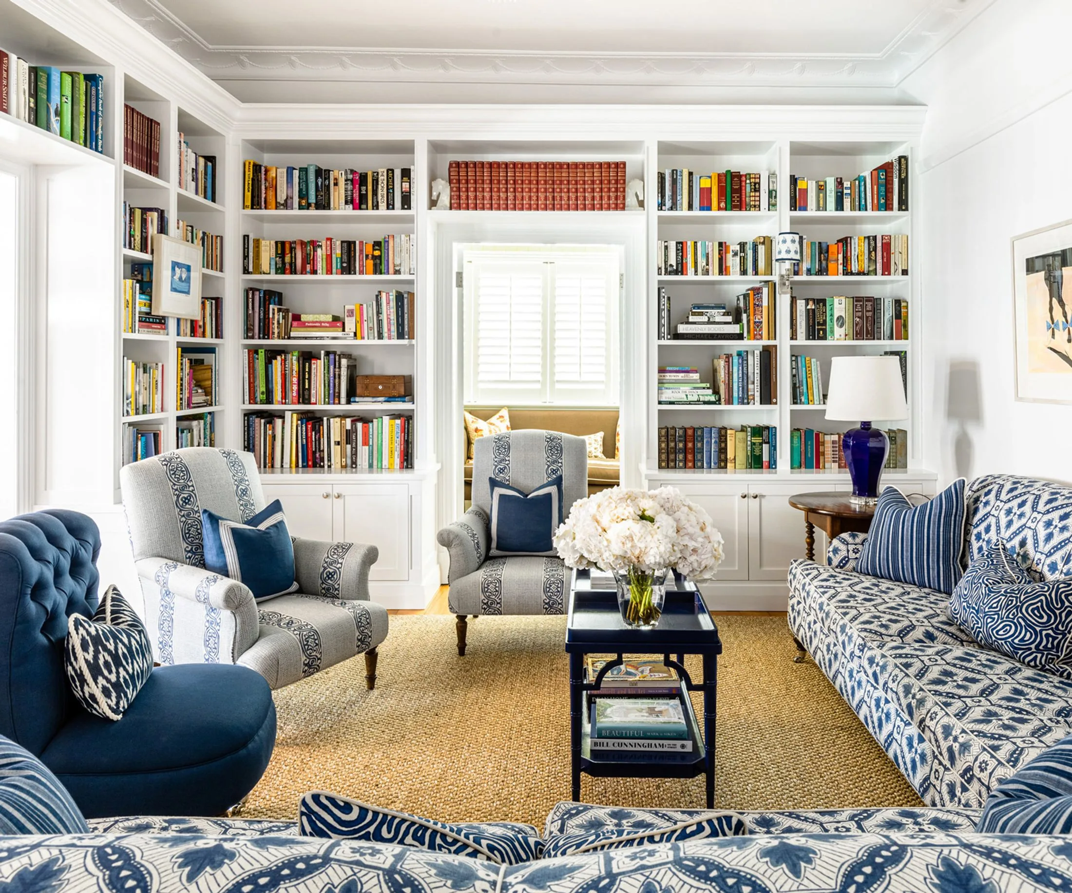 Library living room with blue and white upholstered sofas