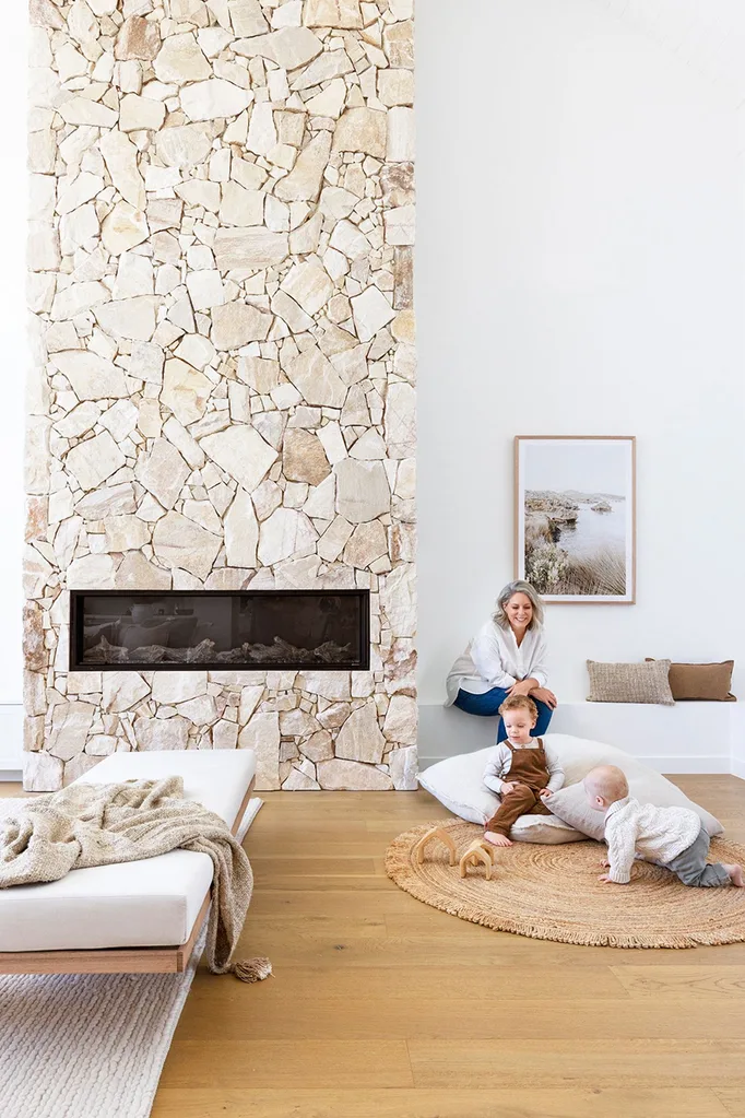 Coastal style living room with stone fireplace
