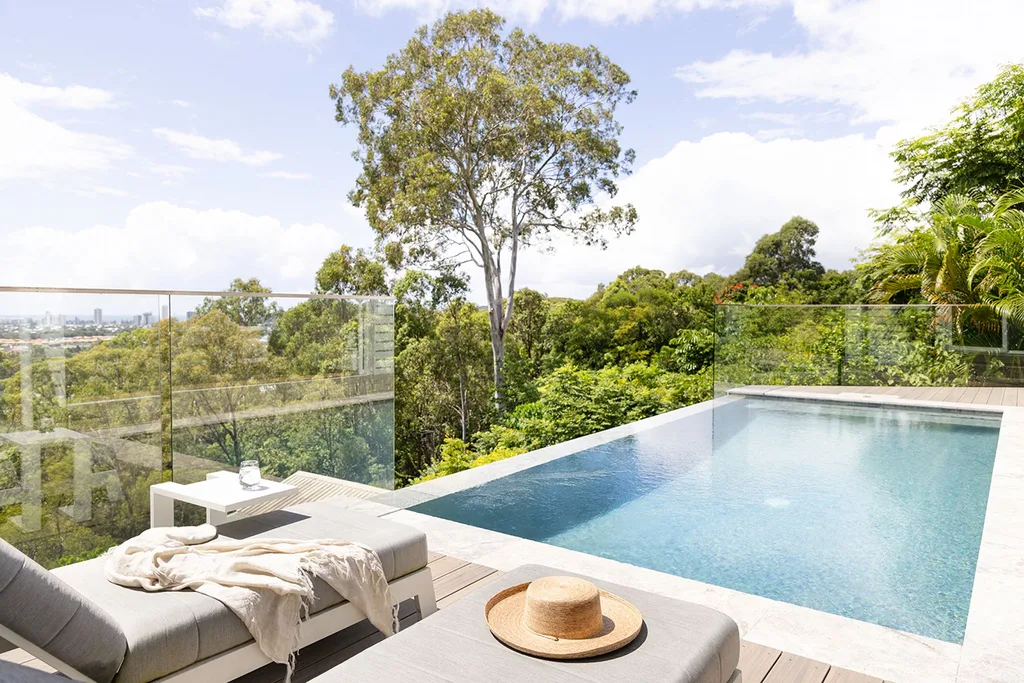 Swimming pool overlooking bush and city views
