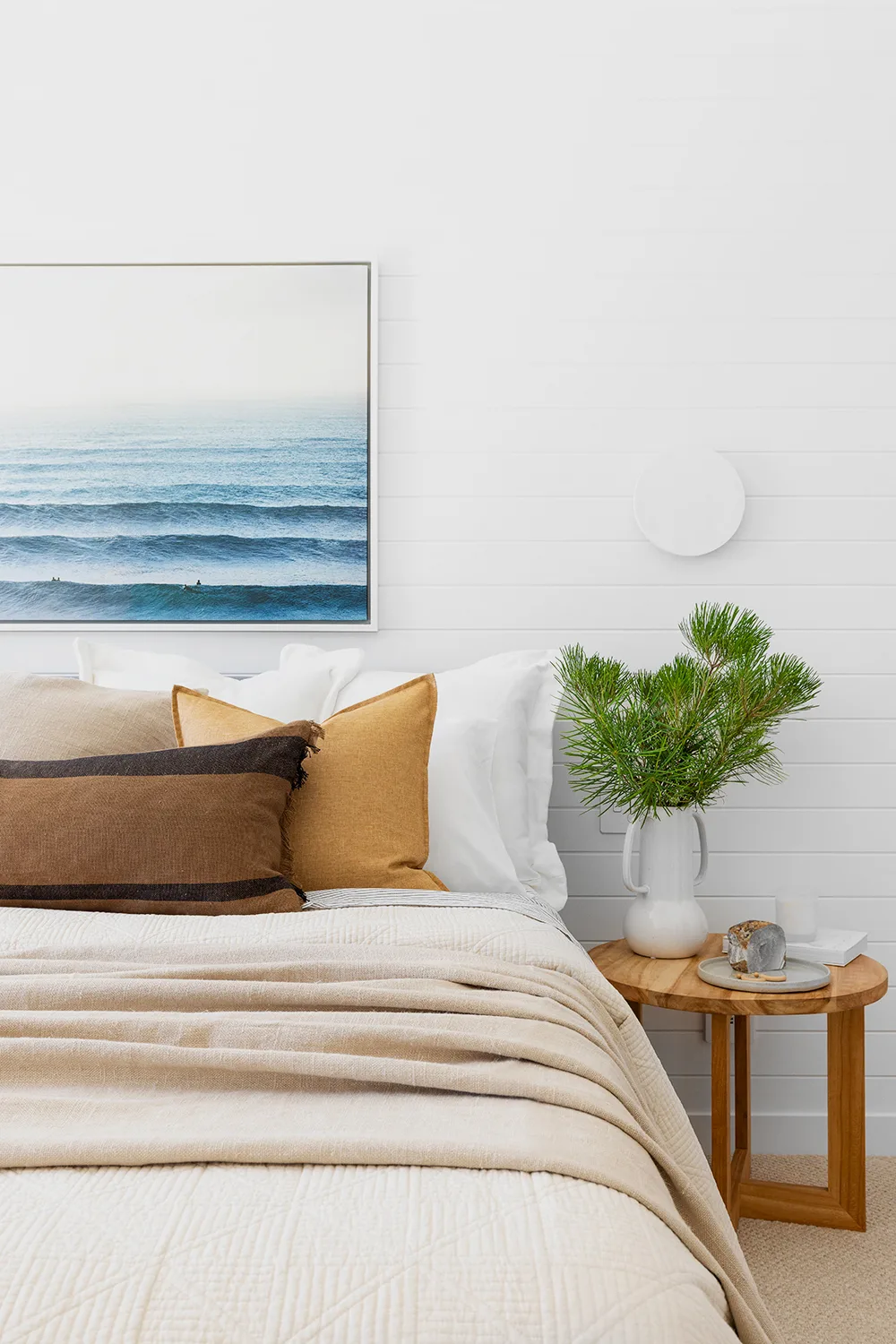 Coastal bedroom with ocean artwork