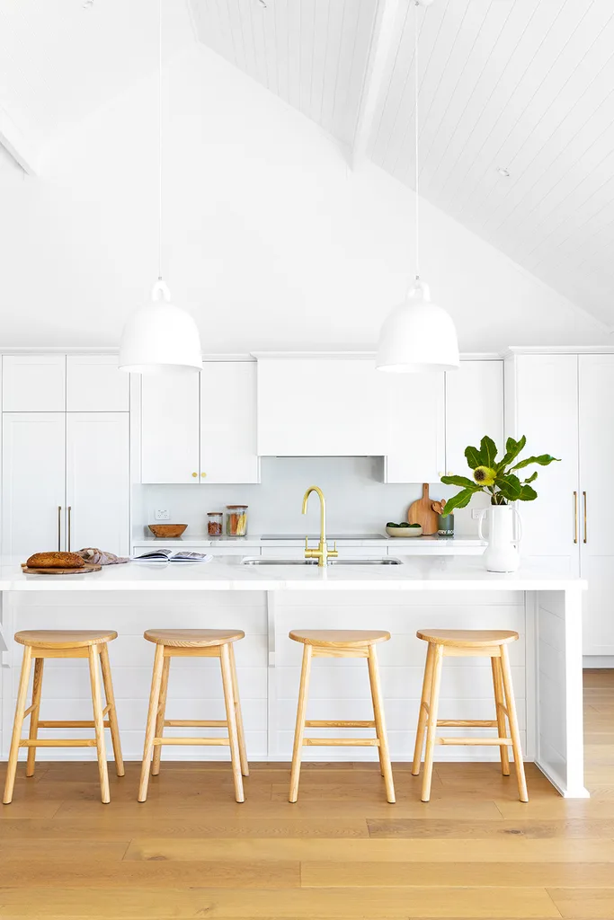 white kitchen with timber bar stools ad kitchen island