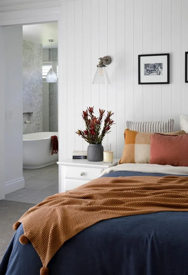 Main bedroom with a bed dressed in navy and terracotta