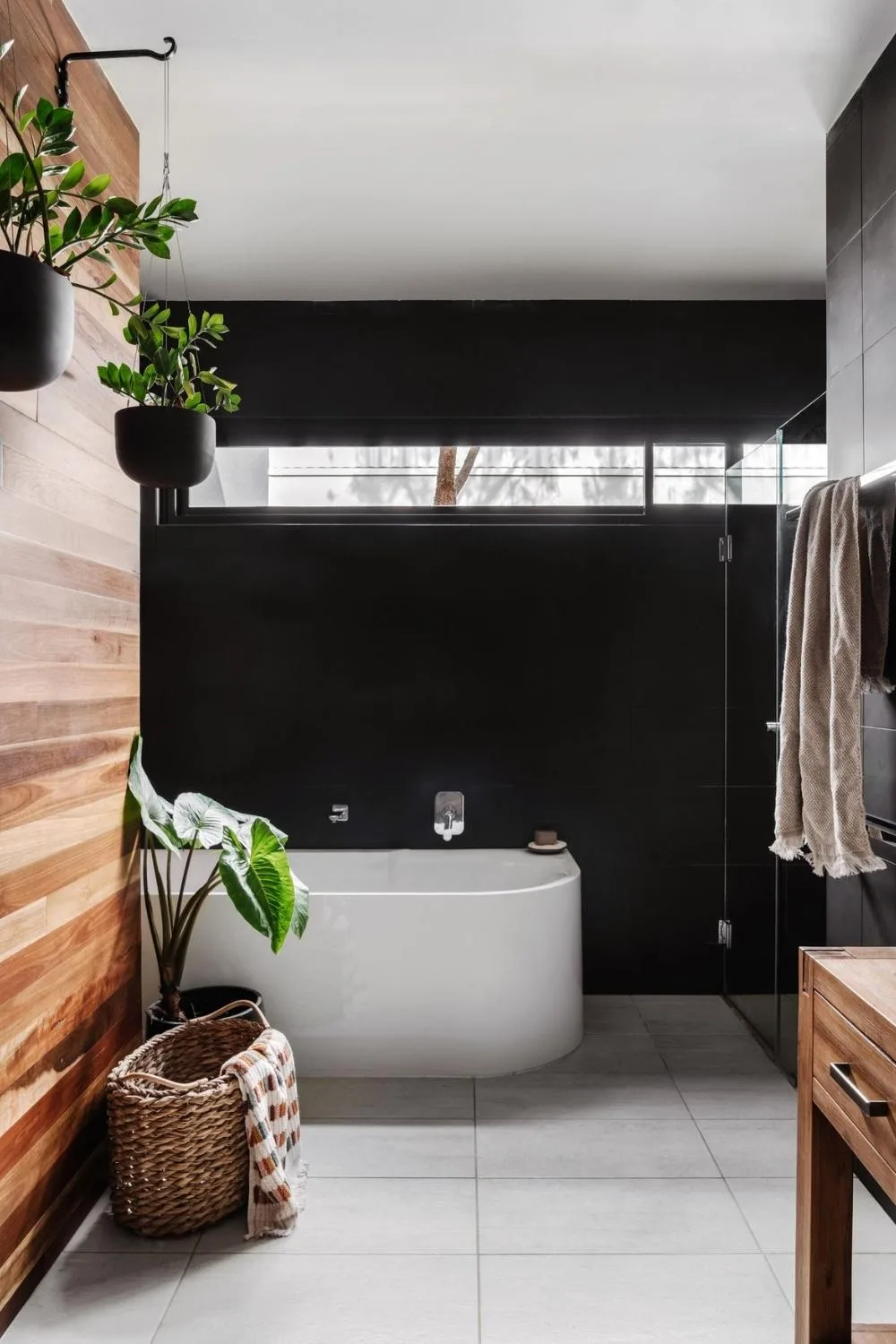 Timber and black bathroom with hanging potted zanzibar gem plants