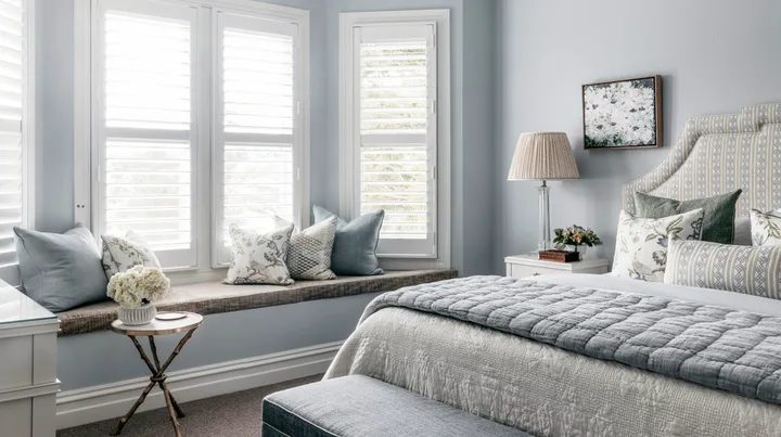 pale blue main bedroom with window seat