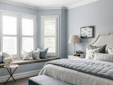 pale blue main bedroom with window seat