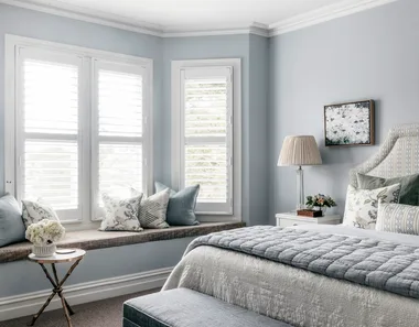 pale blue main bedroom with window seat