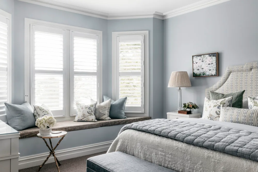 pale blue main bedroom with window seat