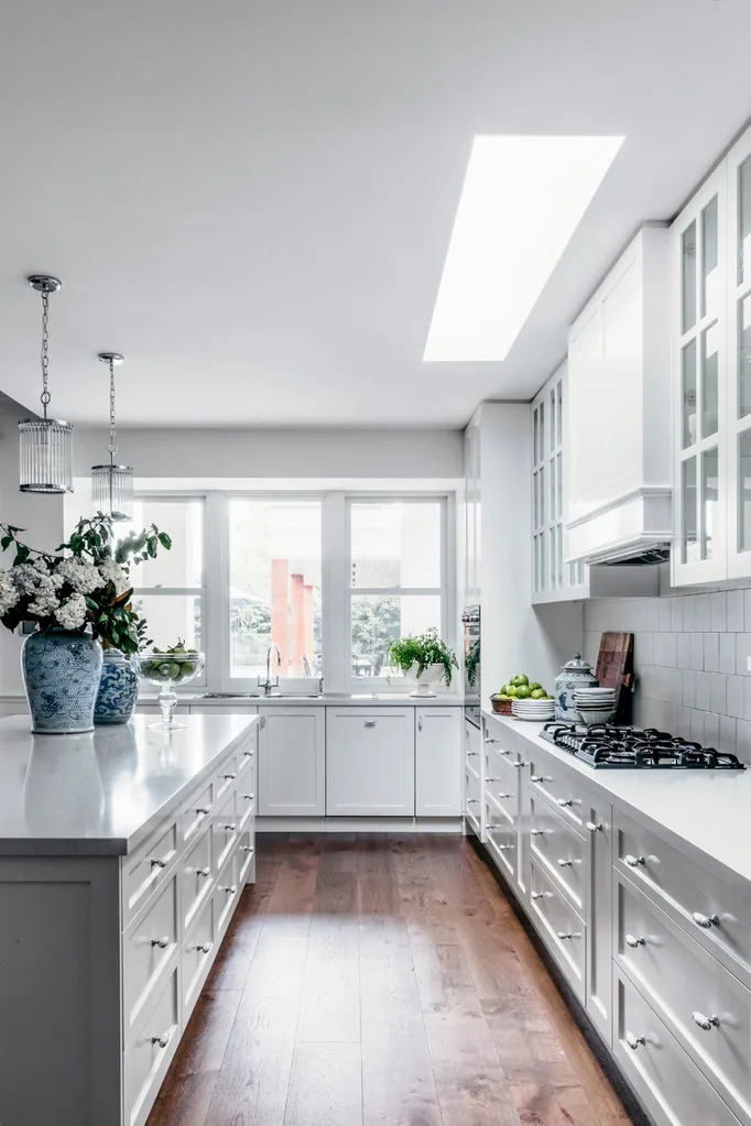 Hamptons style kitchen with large island bench and ginger jar vases