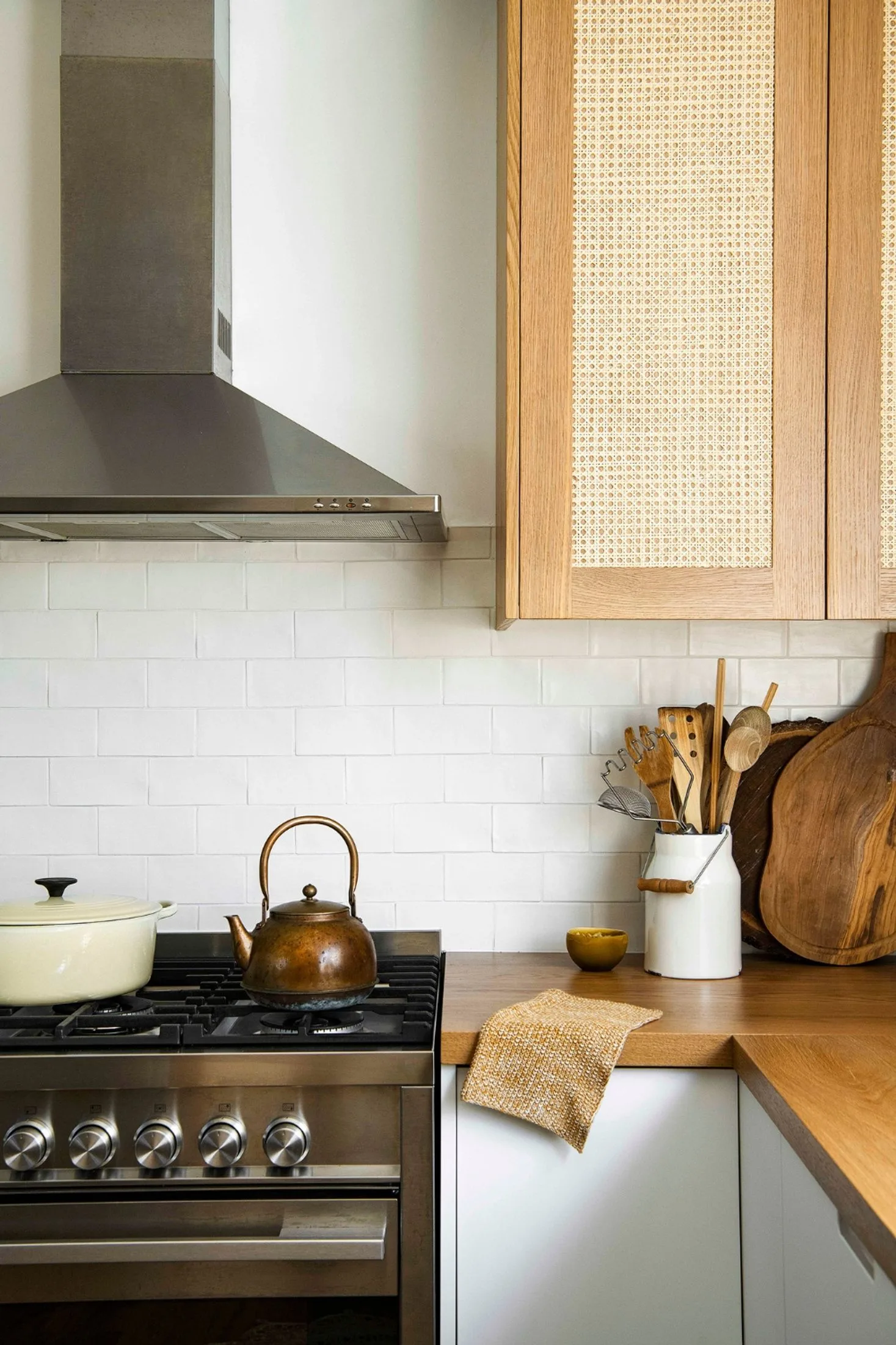 Country style kitchen with stainless steel stove and oven unit