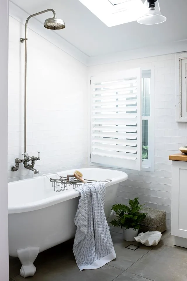 white bathroom with vintage clawfoot bathtub