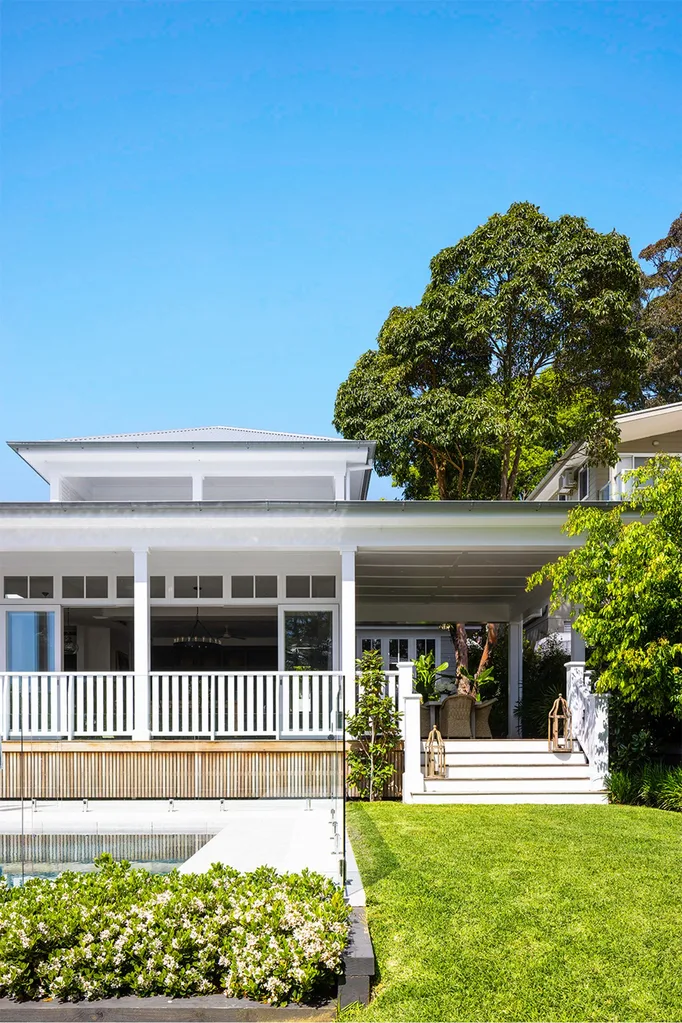 coastal home exterior with lawn and swimming pool