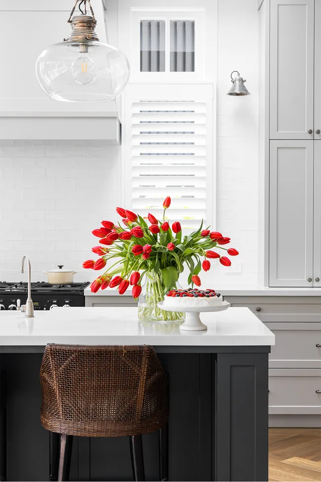 Navy blue kitchen island with red tulips