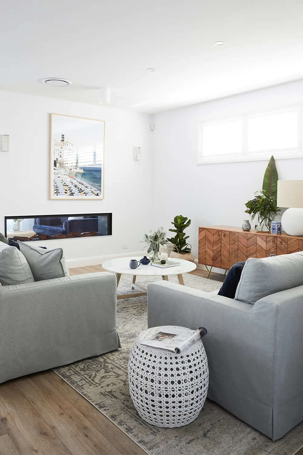 Contemporary living room with built-in fireplace and frey sofas