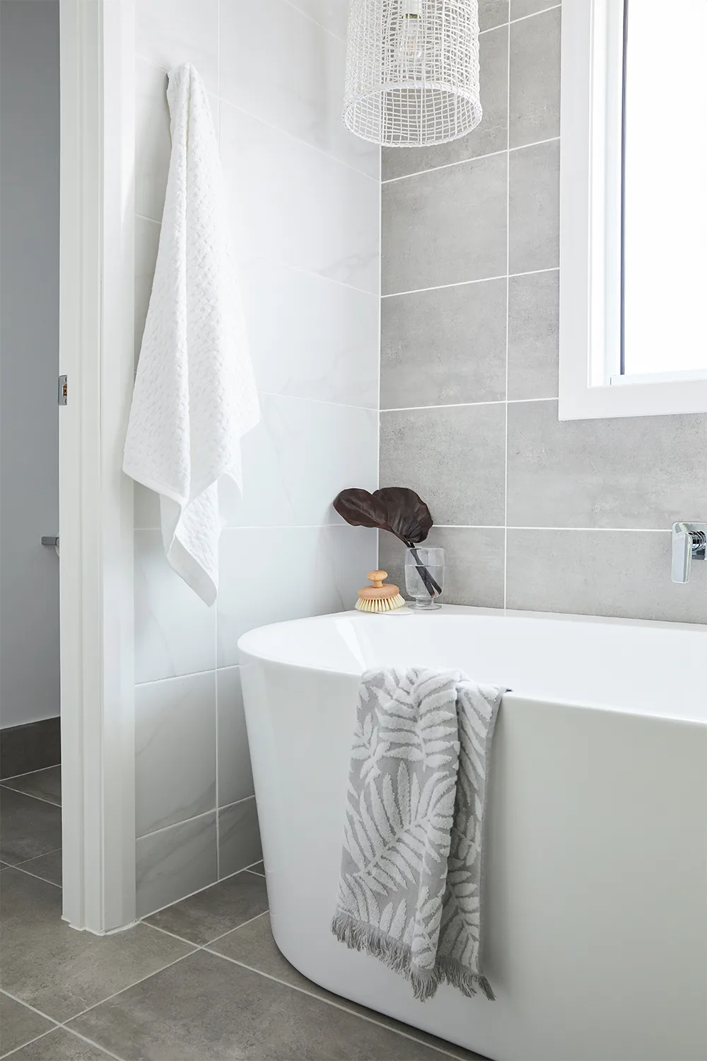 Grey and white ensuite with sfreestanding bathtub