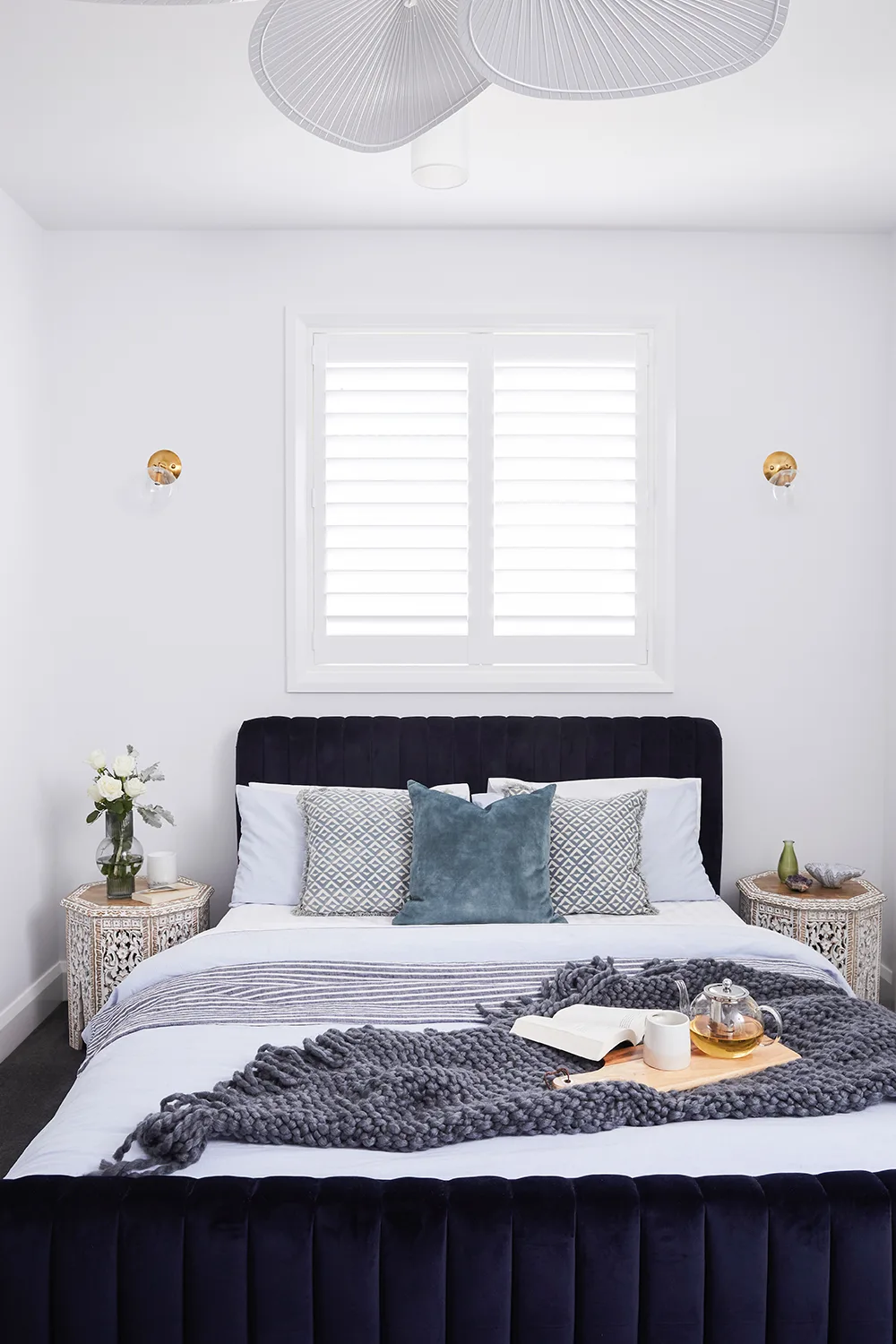 Navy blue and white bedroom with navy blue velvet bedhead