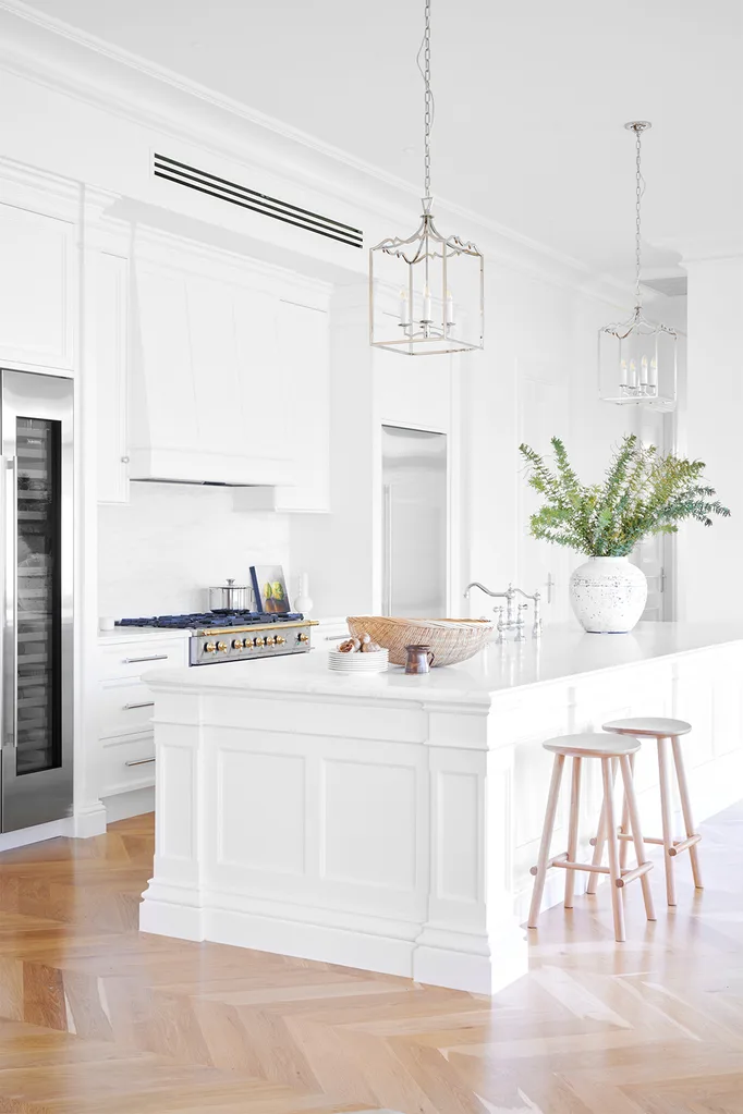 Hamptons style interior design trending white kitchen with moulded kitchen island and light herringbone floors