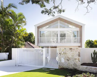 Contemporary coastal home exterior with stone feature wall