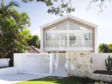Contemporary coastal home exterior with stone feature wall