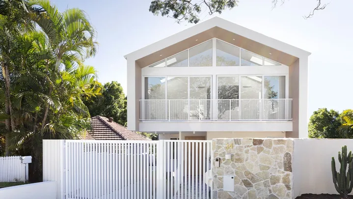 Contemporary coastal home exterior with stone feature wall