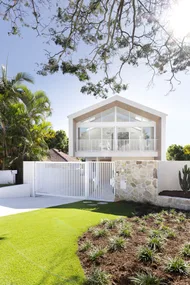 Contemporary coastal home exterior with stone feature wall