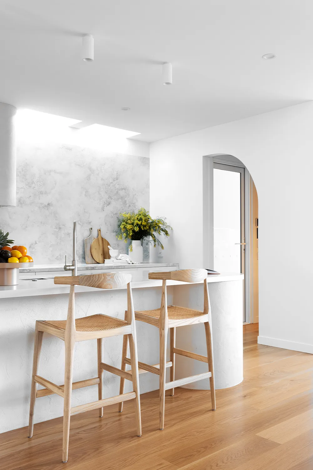 contemporary minimalist kitchen with gray quartz splashback