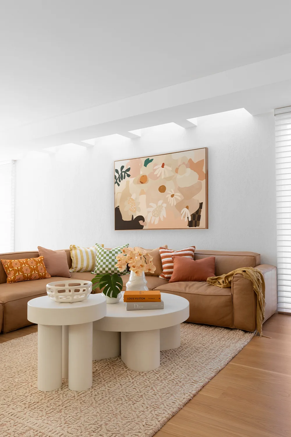 Contemporary living room with leather sofa and concrete nested coffee tables