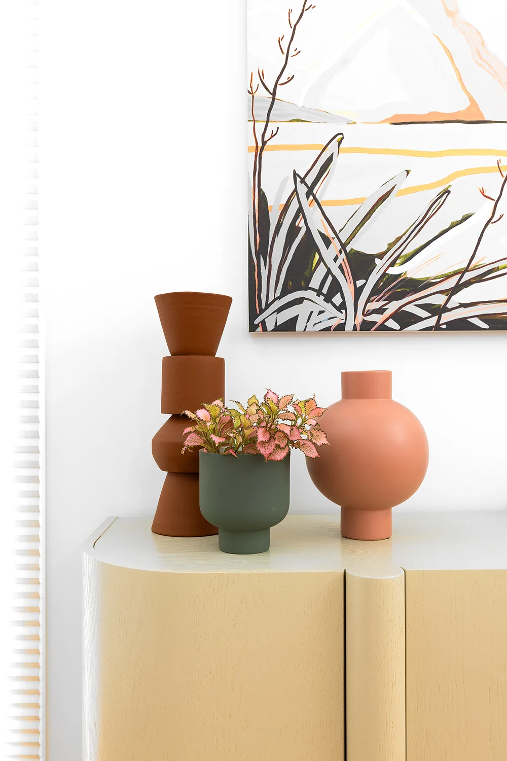 Contemporary minimal sideboard with terracotta vases