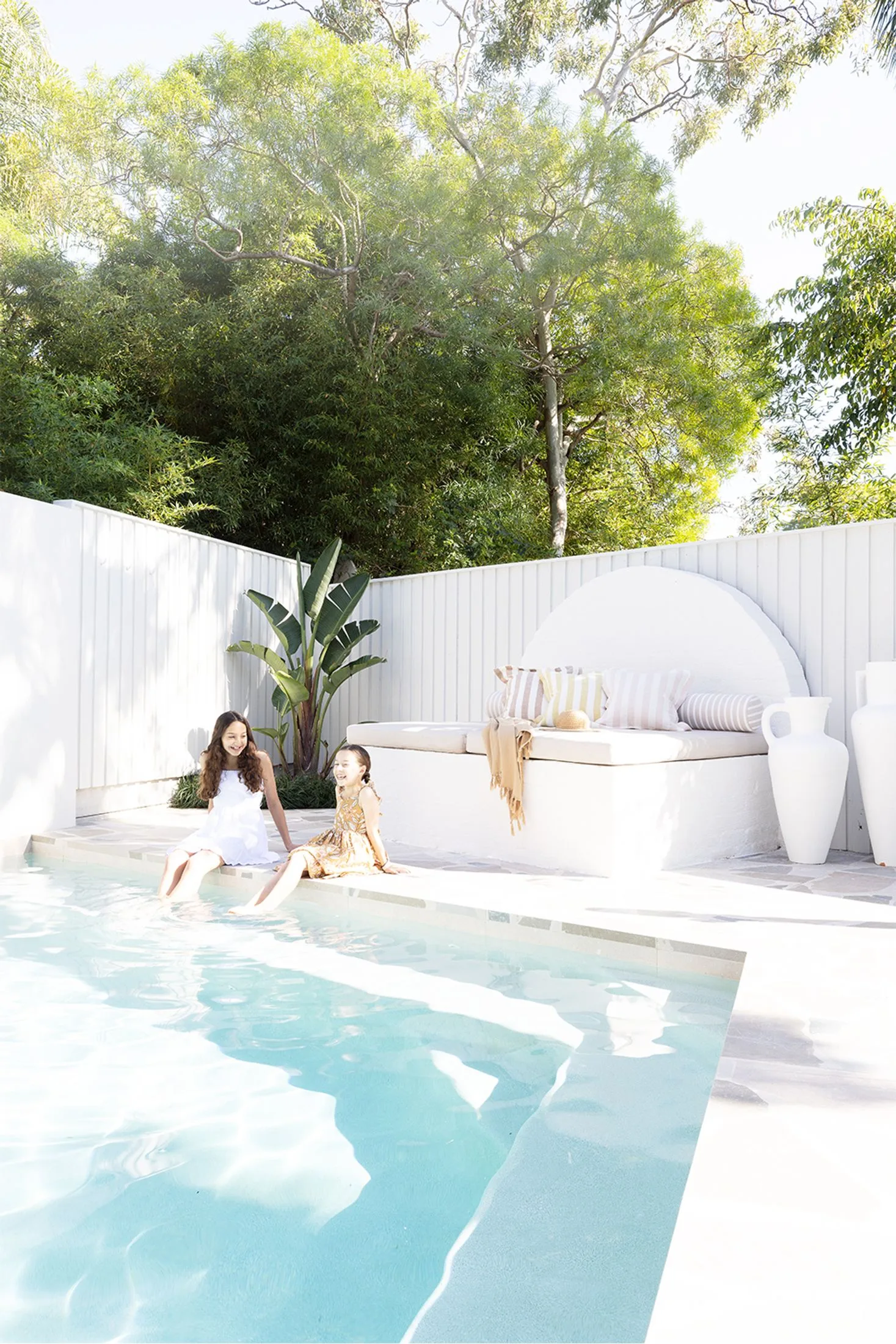 Contemporary swimming pool with custom curved concrete daybed