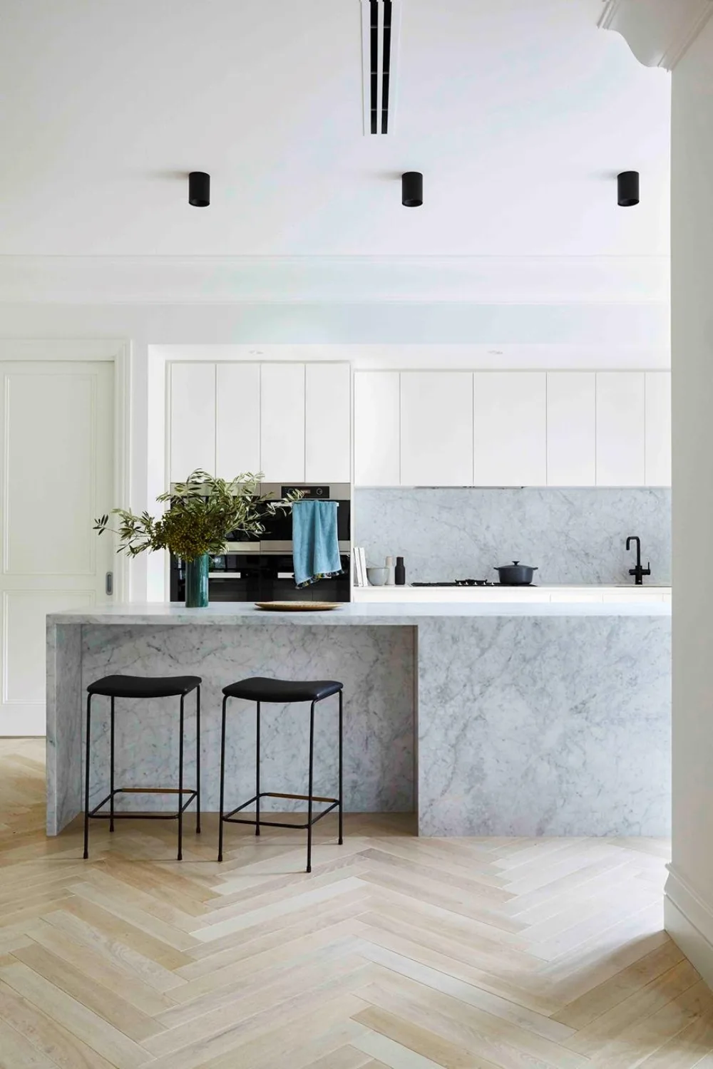 Marble kitchen with herringbone timber floors