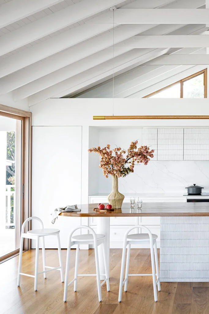 Contemporary coastal kitchen with finger tiles on island bench