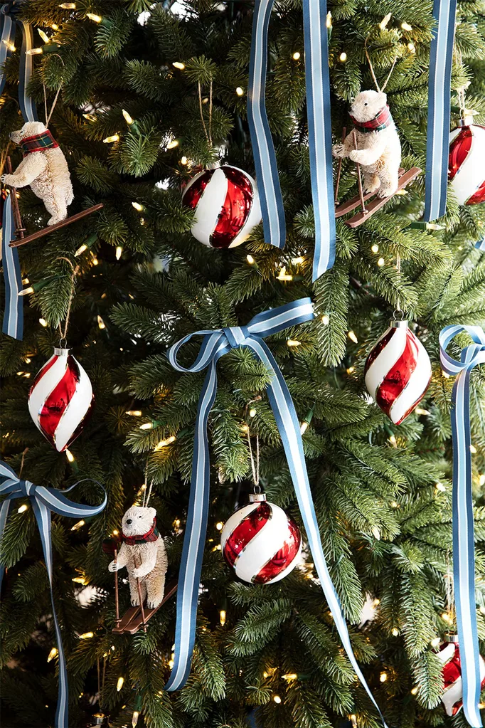 Christmas tree decorated in blue and silver with red striped baubles