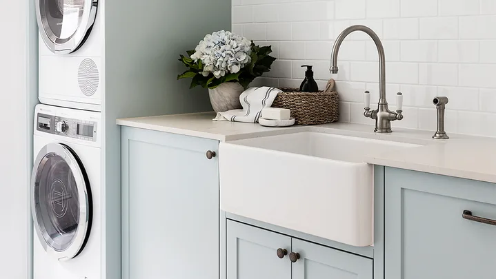 Pale blue laundry hanging rail stacked washer dryer
