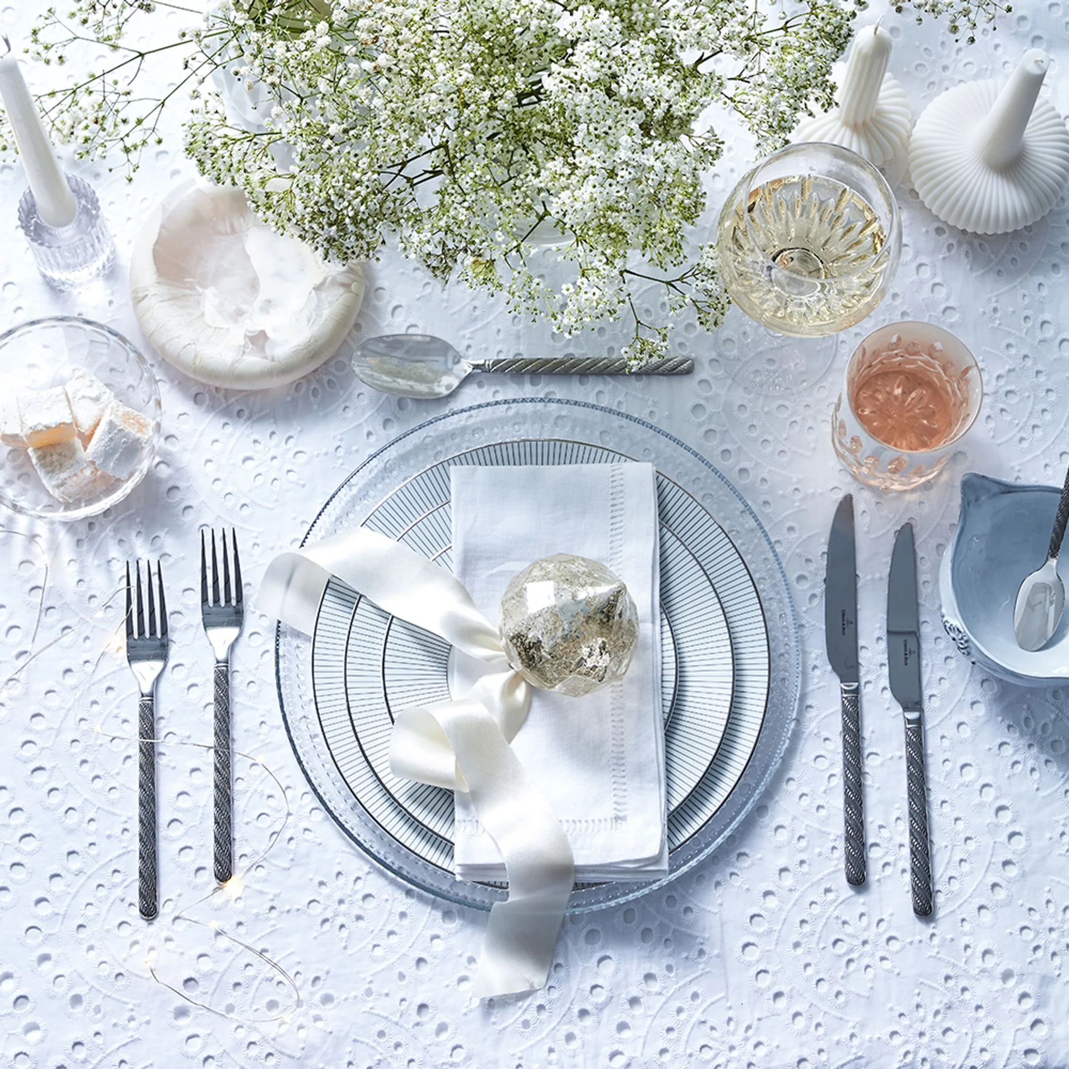 Delicate white and silver Christmas table setting