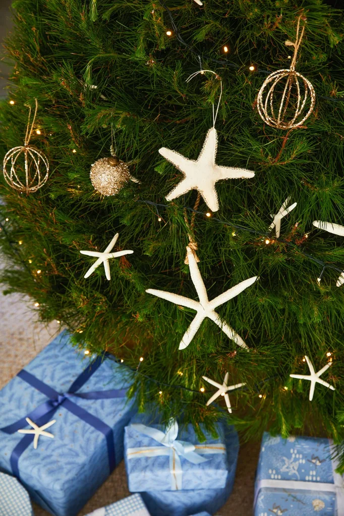 Real Christmas tree decorated with coastal style baubles