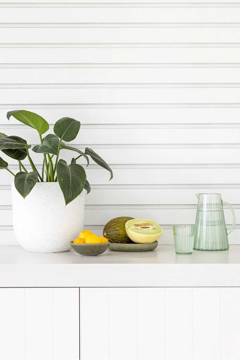 Alfresco dining area with white weatherboard exterior