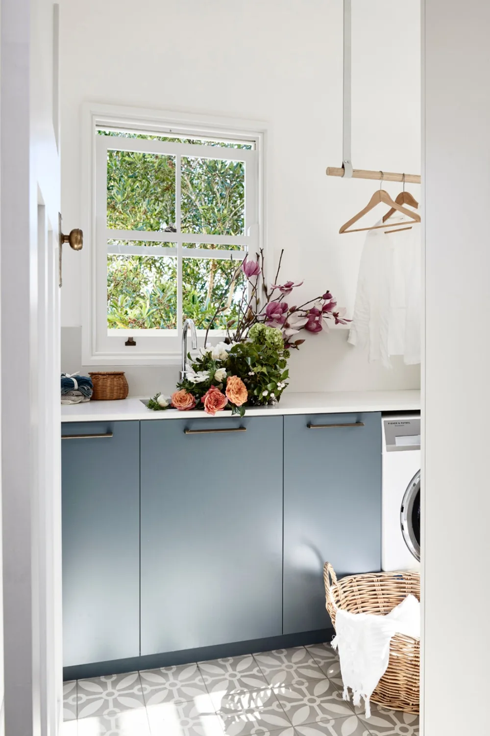 Laundry with blue cabinetry