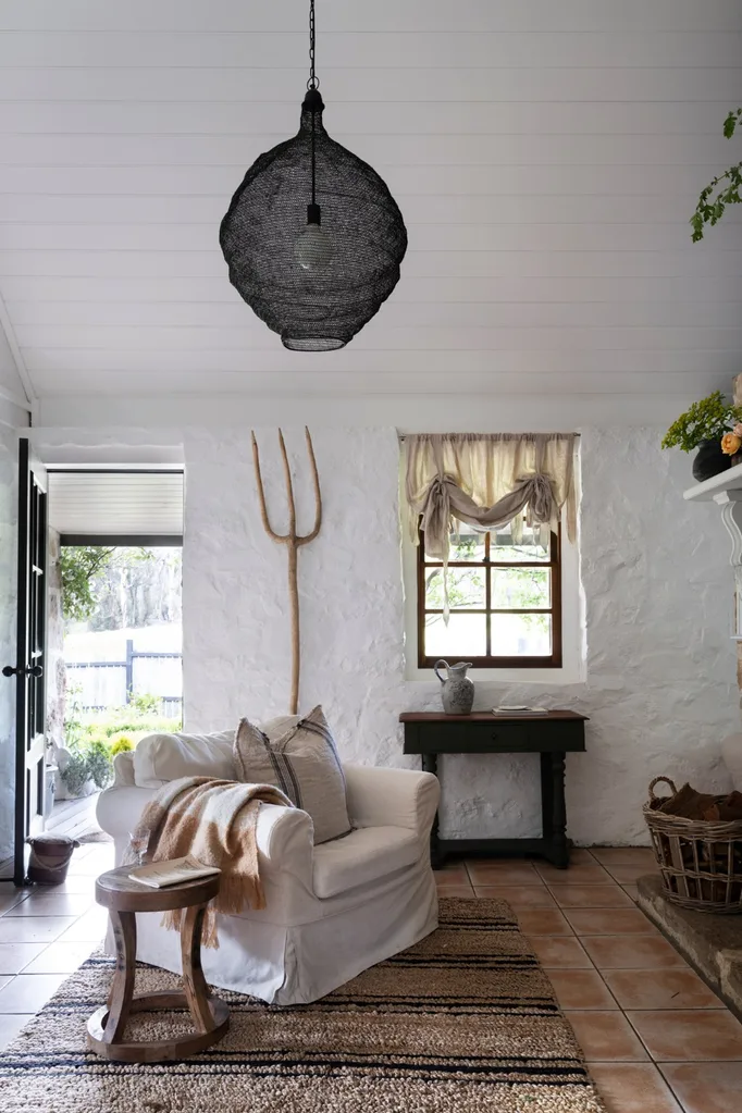 Front door opening into living room of a stone cottage