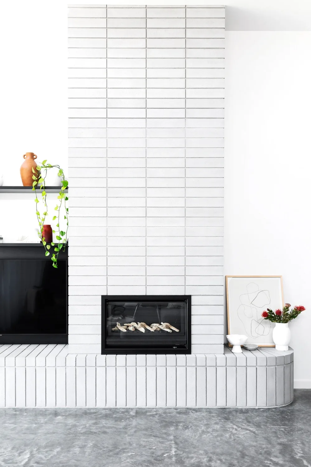 White brick fireplace with cascading indoor plant