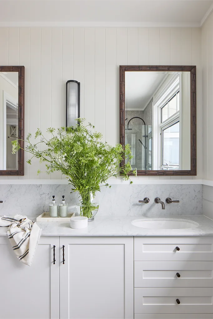 Antique mirrors over twin marble vanity basins