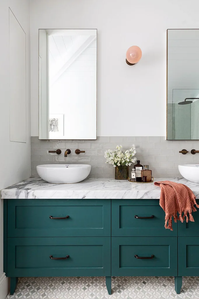 Teal bathroom cabinets with marble vanity