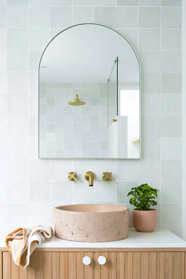 Coastal style bathroom vanity with round pink concrete basin