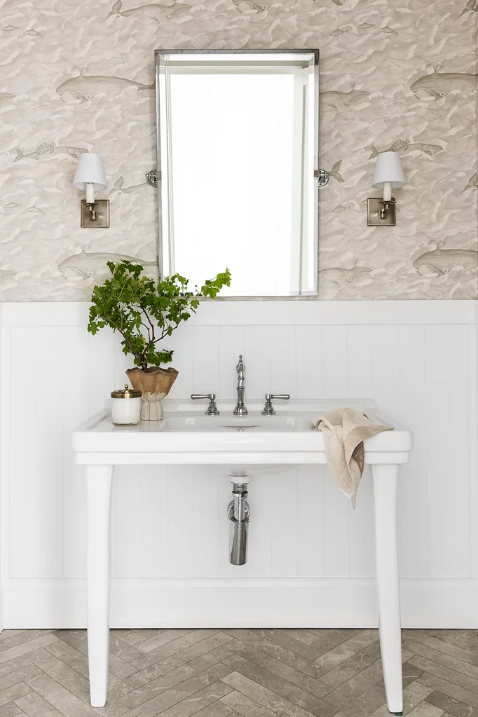 White powder room with tumble stone herringbone floor tiles freestanding basin and VJ wall panelling